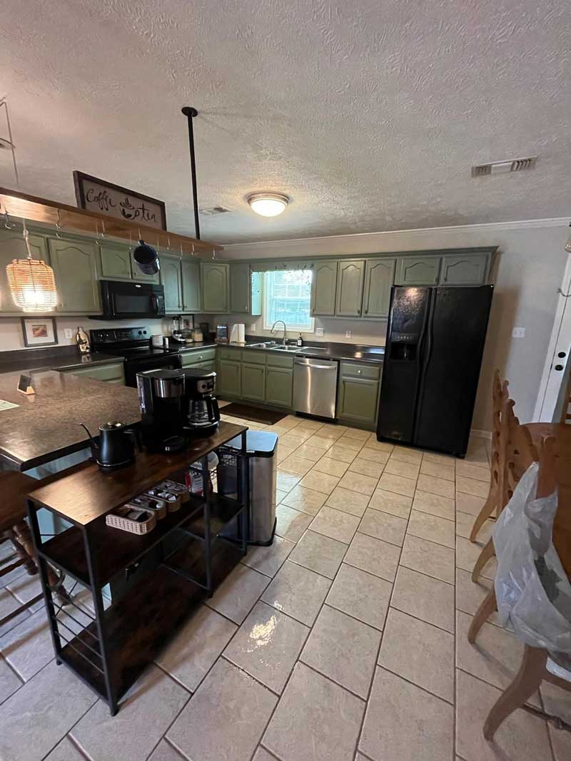 A residential kitchen with a shiny tile floor